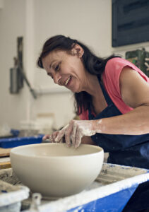 Tsami Ceramics | Art Studio in Corfu wo,an creating a clay bowl